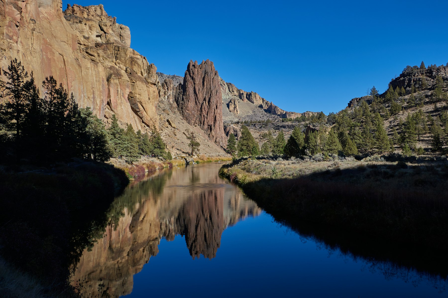 The rock spires of Smith Rock reflected in the Crooked River near Bend Oregon