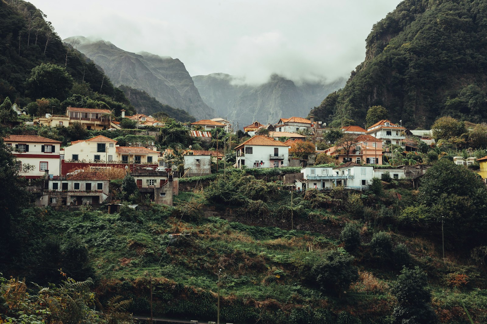Small houses scattered across steep green mountainsides on Madeira
