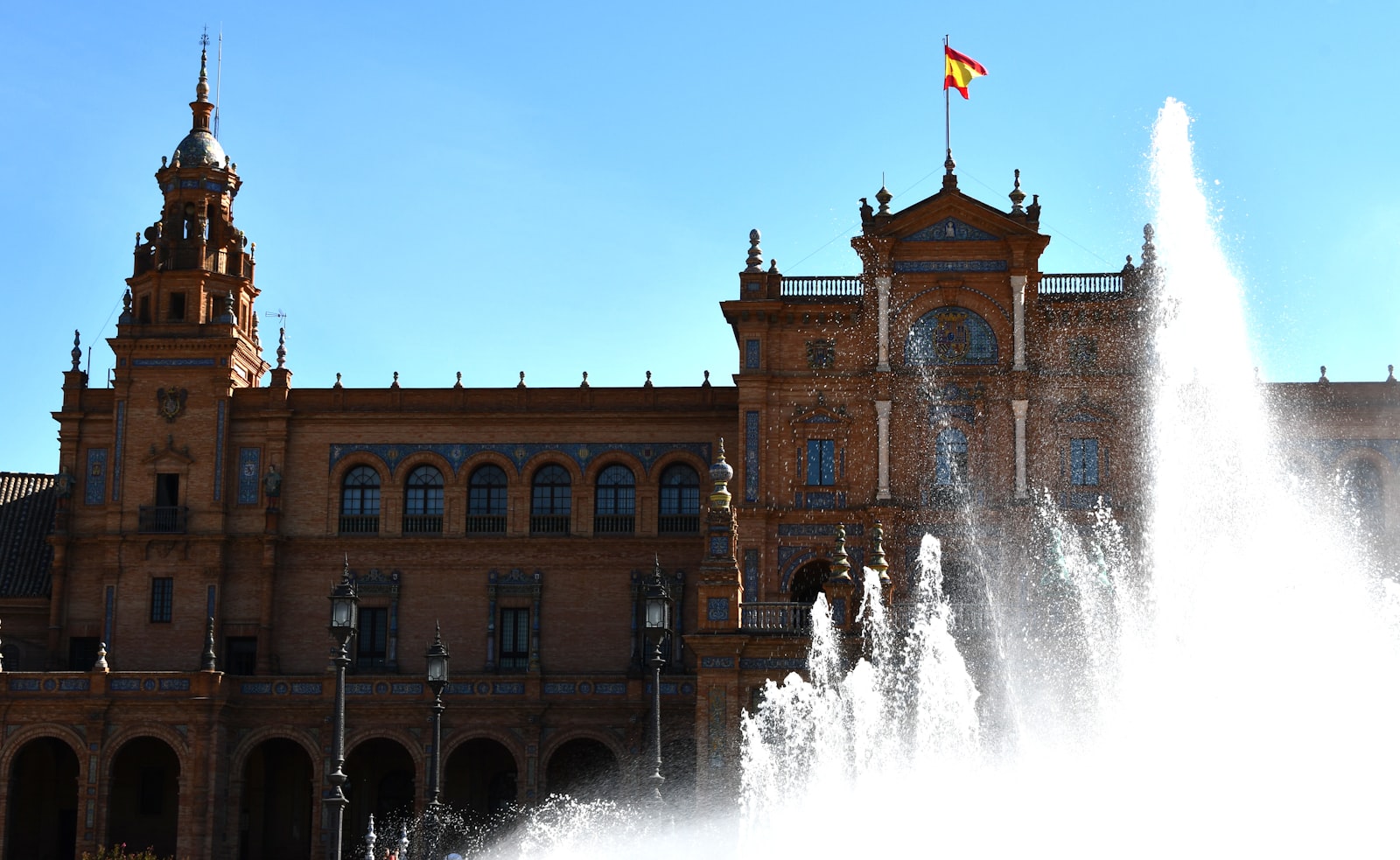 The curved brick arcade and fountain of the Plaza de Espana in Seville