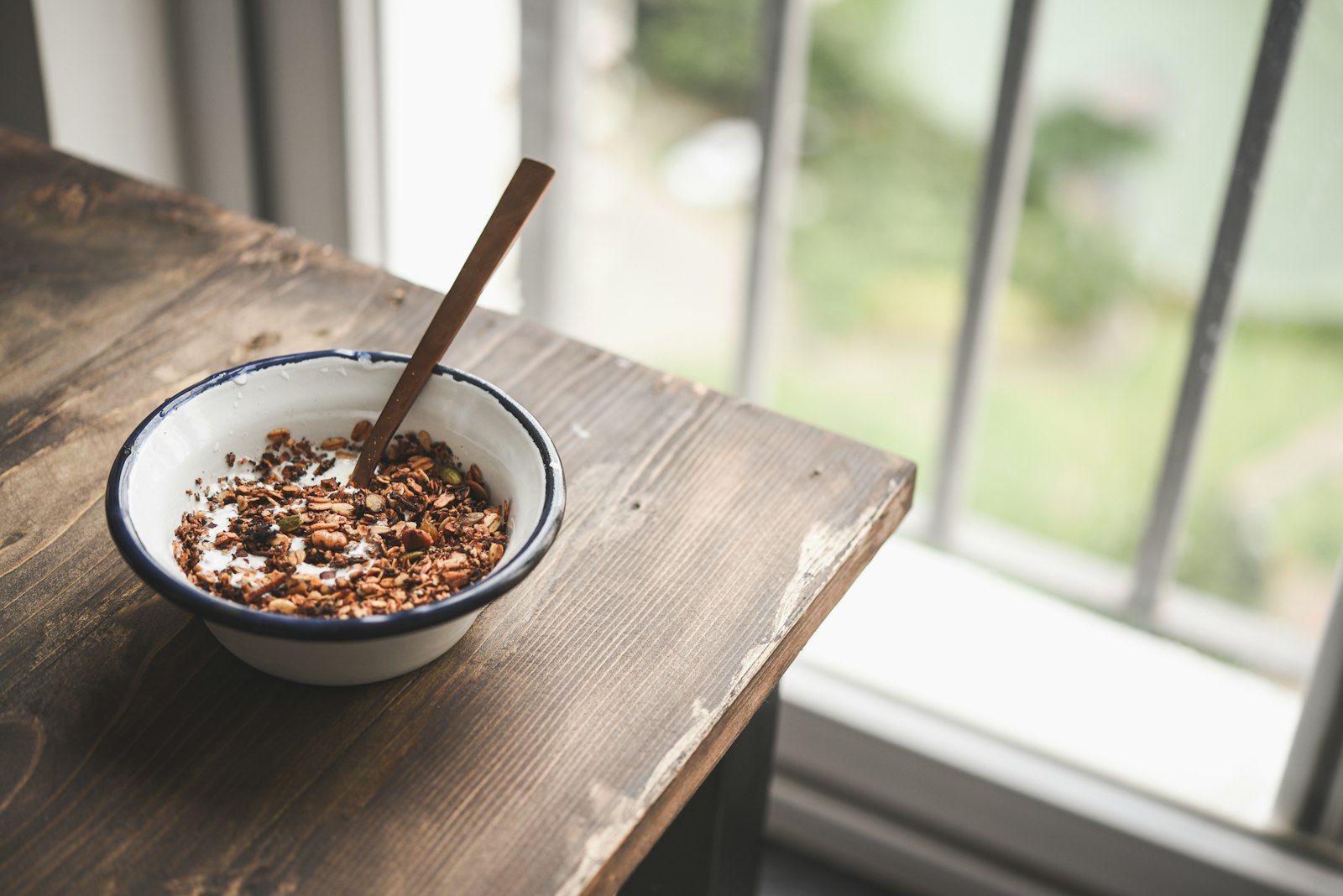 A bowl of bircher muesli on a wooden table