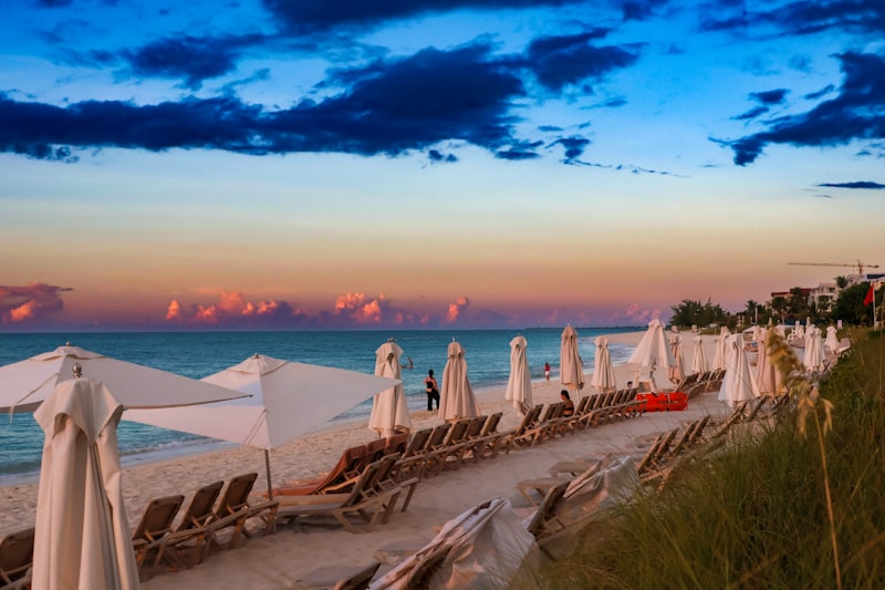 A row of beach chairs on the sand in the Turks and Caicos Islands