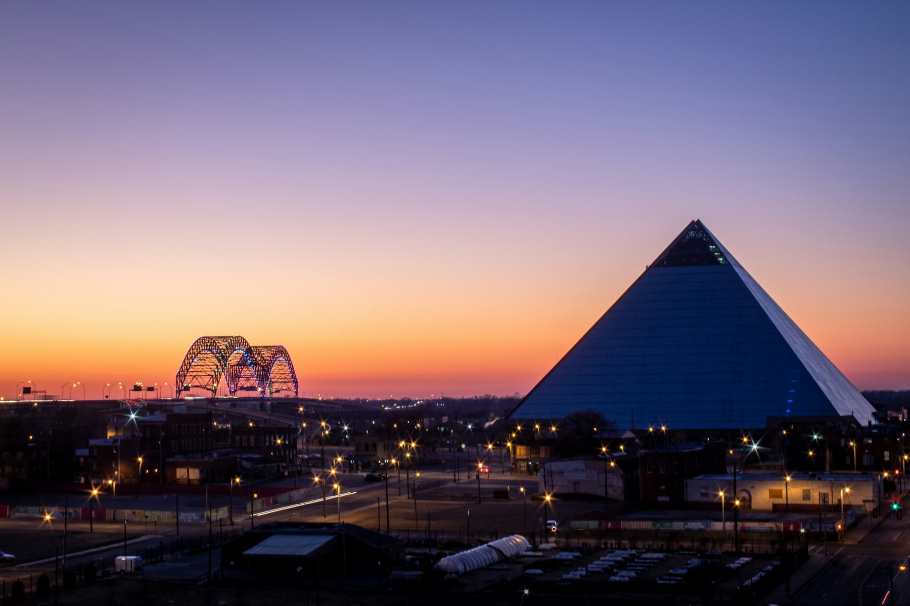 The Memphis Pyramid and the Mississippi River bridge at sunset