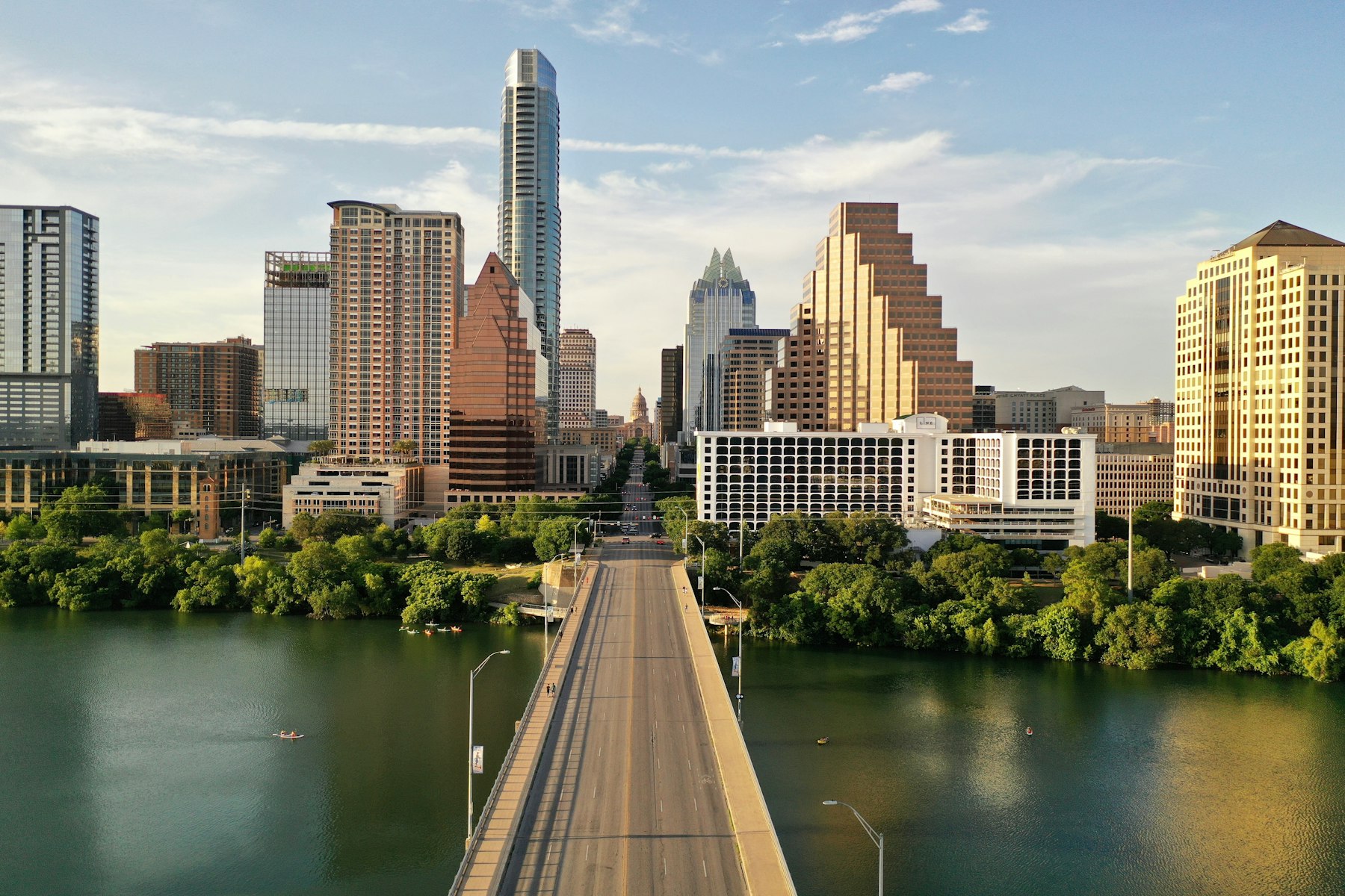A bridge over Lady Bird Lake leading to the downtown Austin Texas skyline