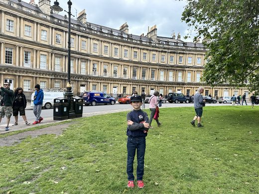 The curved honey colored Georgian townhouses of The Circus in Bath around a lawn of plane trees
