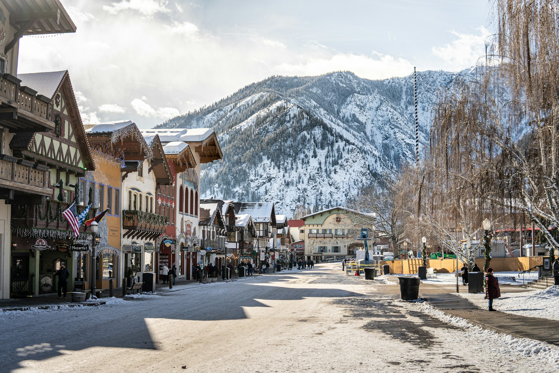The Bavarian style main street of Leavenworth Washington under snow with mountains behind