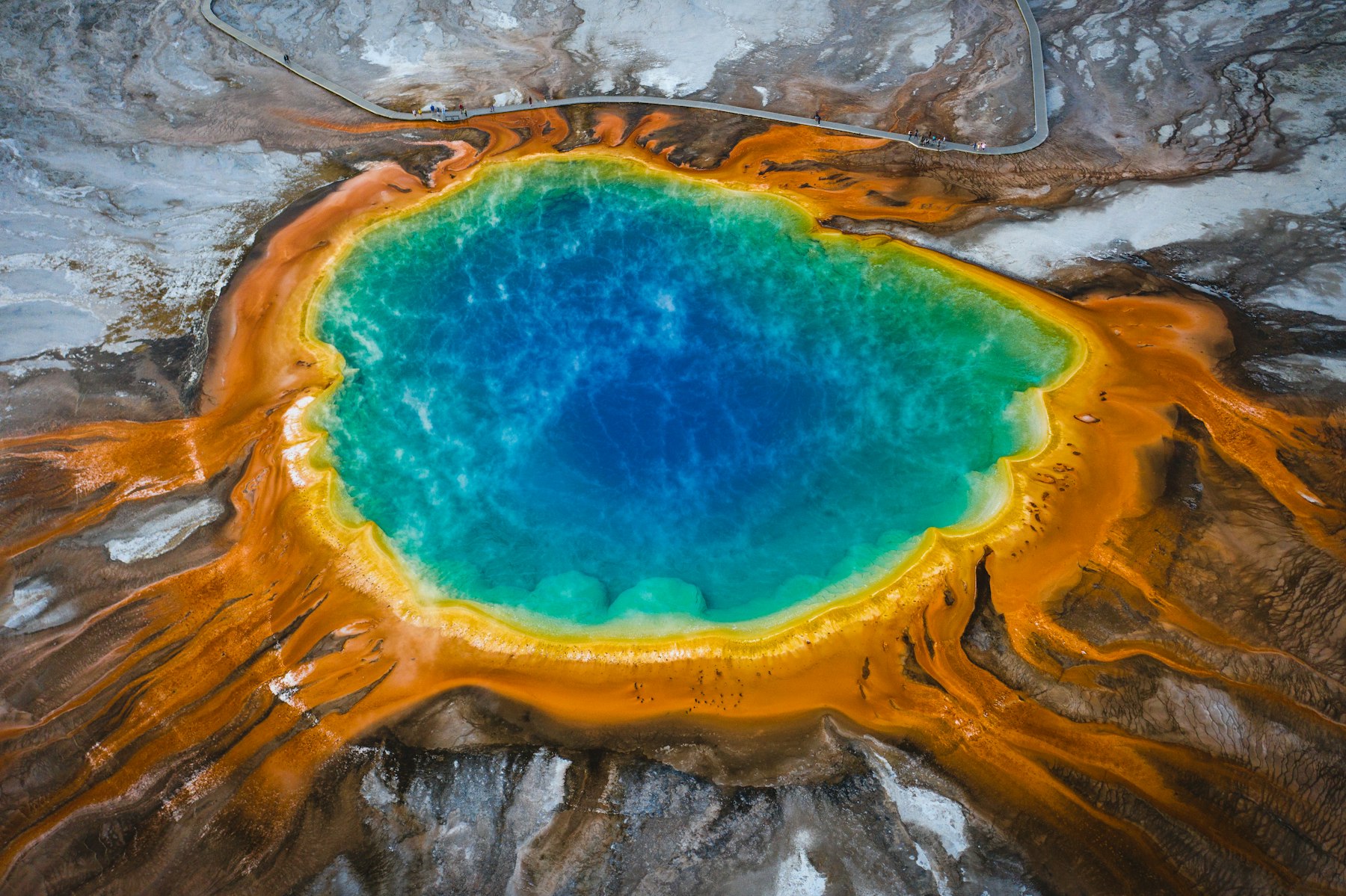 Grand Prismatic Spring seen from above with blue centre and orange bacterial mats