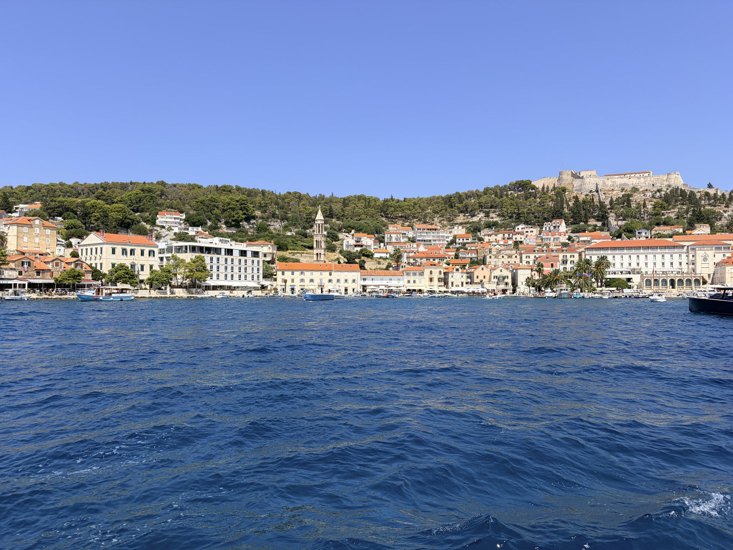 Hvar town and its hilltop fortress seen from the water